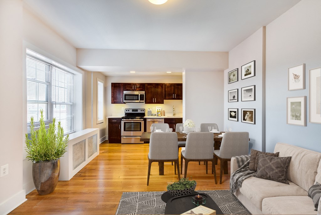 a living room and dining room with a table and chairs