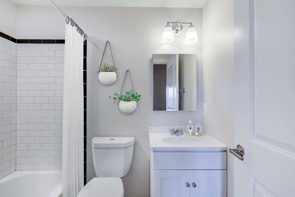 a white bathroom with a white toilet and a sink
