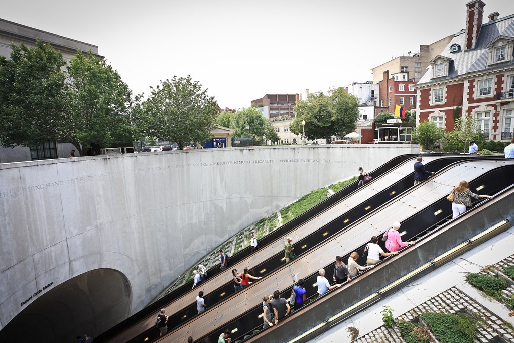 people on the escalators at the subway station