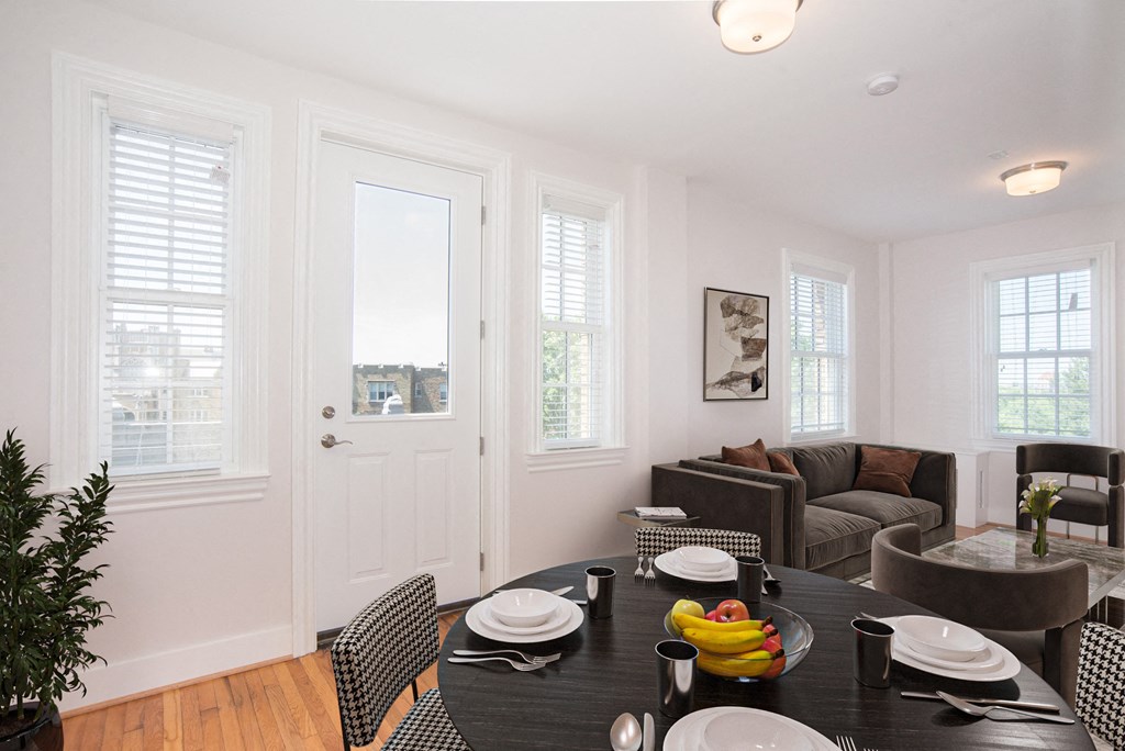 a dining room with a table and chairs and a living room