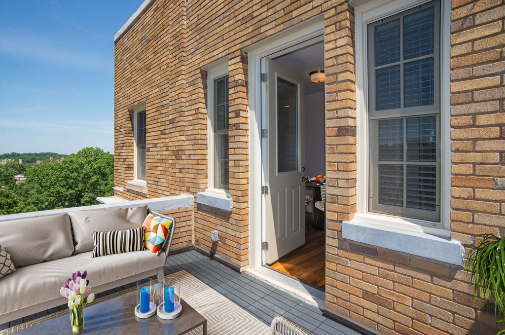 a balcony with a couch and a table