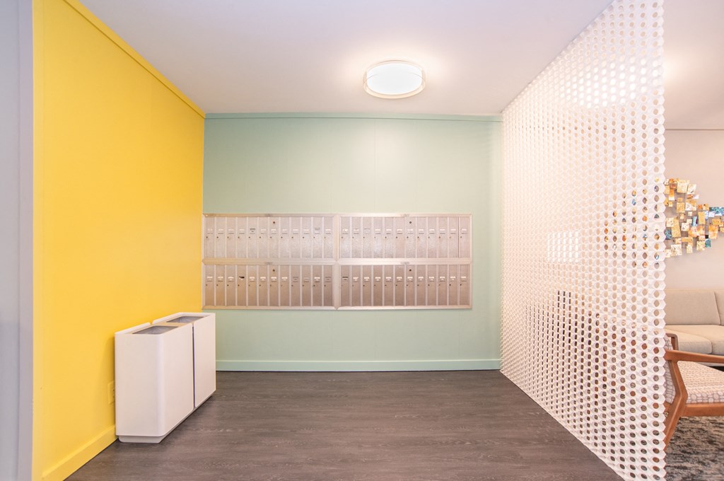 a living room with yellow and white walls and a white room divider