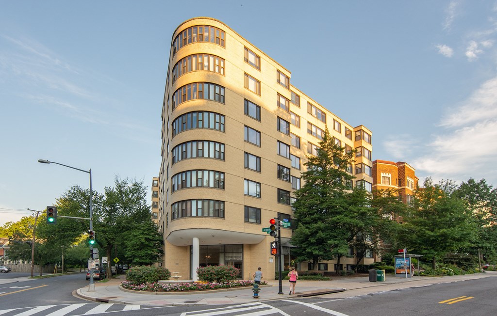 a tall building on the corner of a city street