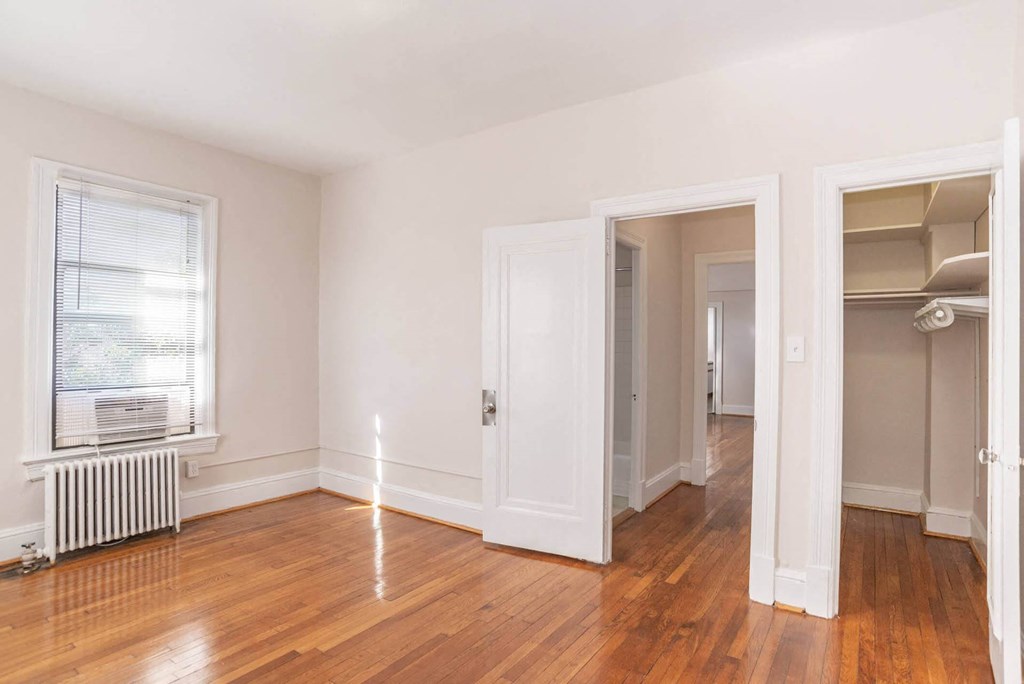 a living room with a hard wood floor and a closet