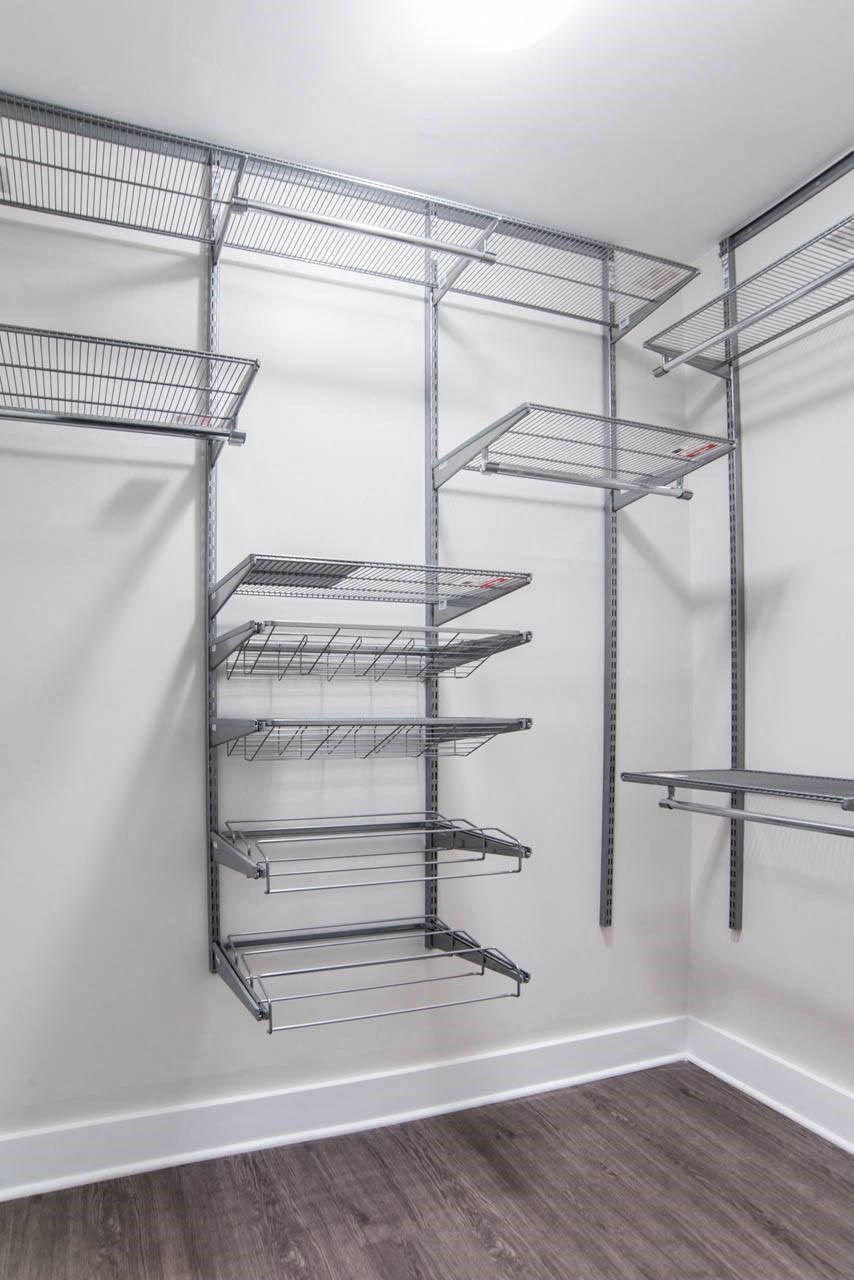 a clean closet with empty shelves in a room