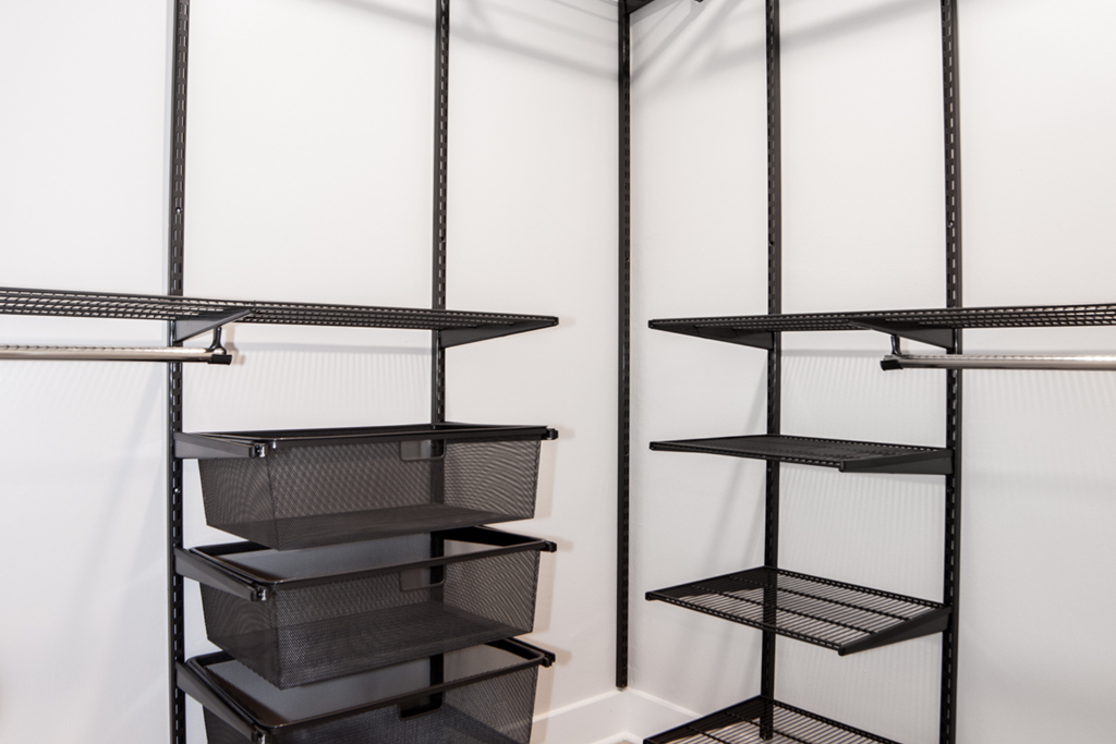 a shelf with baskets on it in a closet