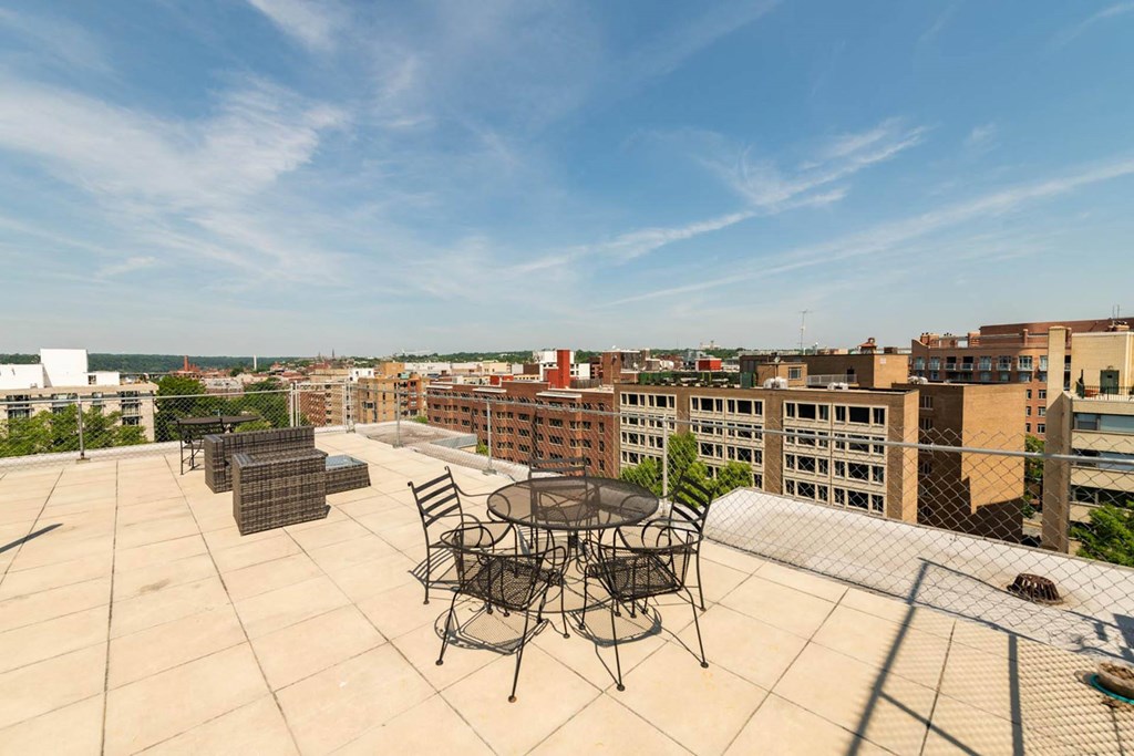 a rooftop patio with a view of the city