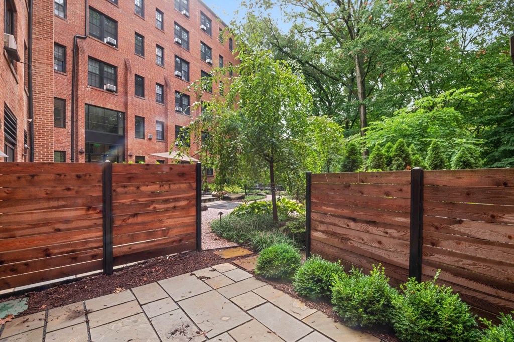 a wooden fence in front of a brick building