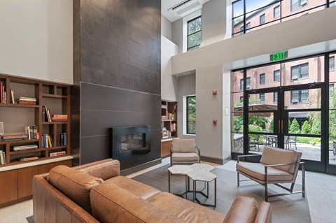 a living room with a couch and chairs and a fireplace