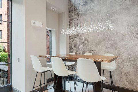 a dining room with a table and chairs and a chandelier