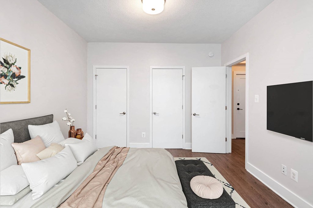 a bedroom with a large bed and a tv