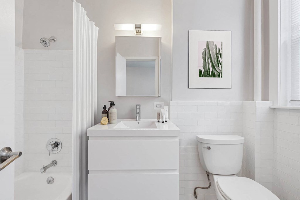 a white bathroom with a sink and a toilet