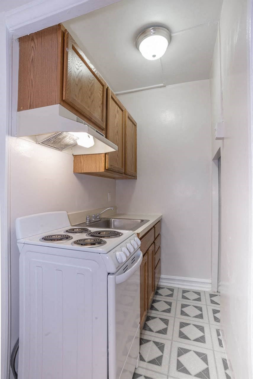 a small kitchen with a stove and a sink