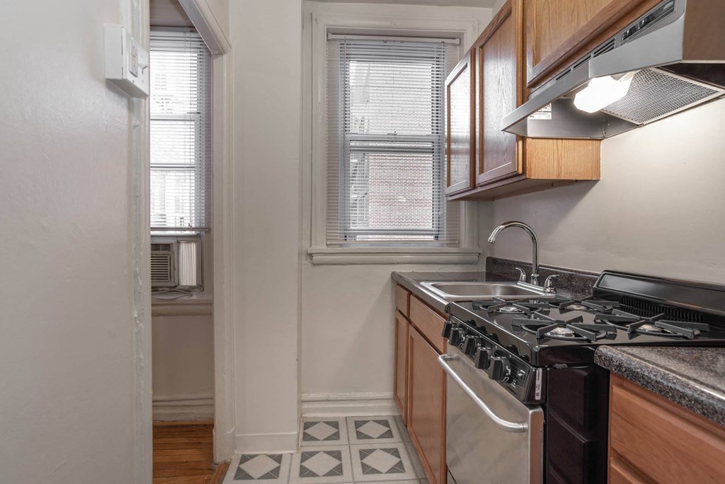 a kitchen with a stove and a window