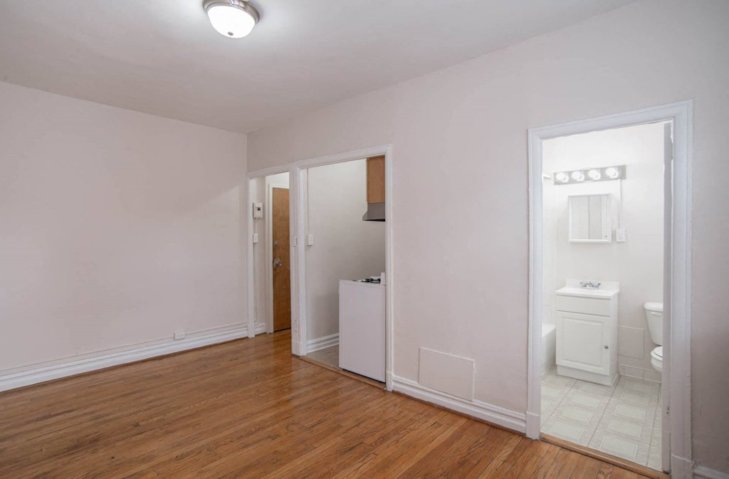 a living room with a door to a bathroom and a toilet