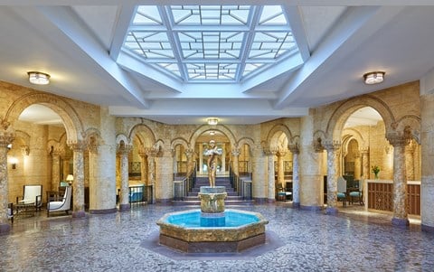 lobby with a fountain and a glass ceiling