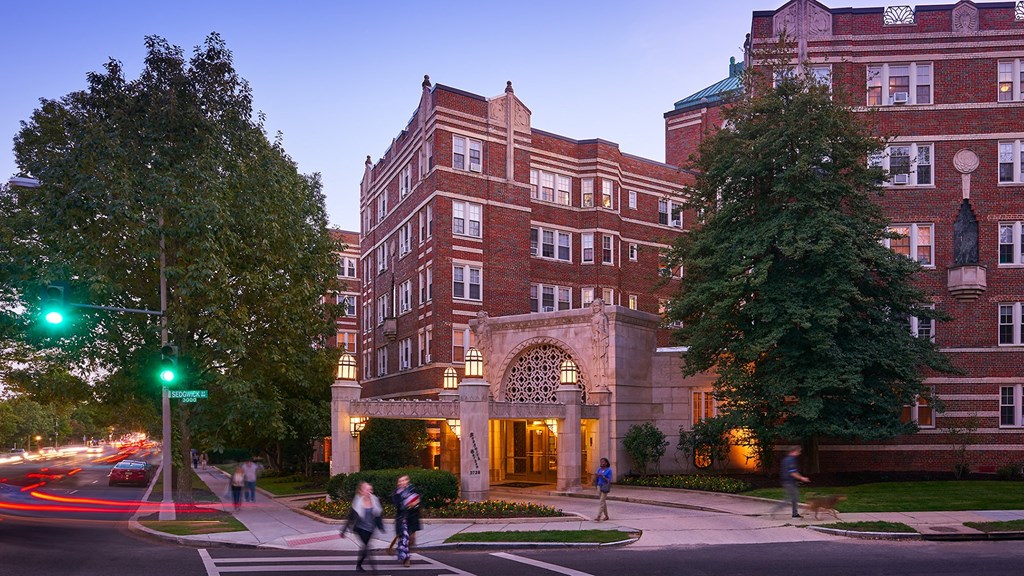 exterior of building on the corner of a city street at dusk