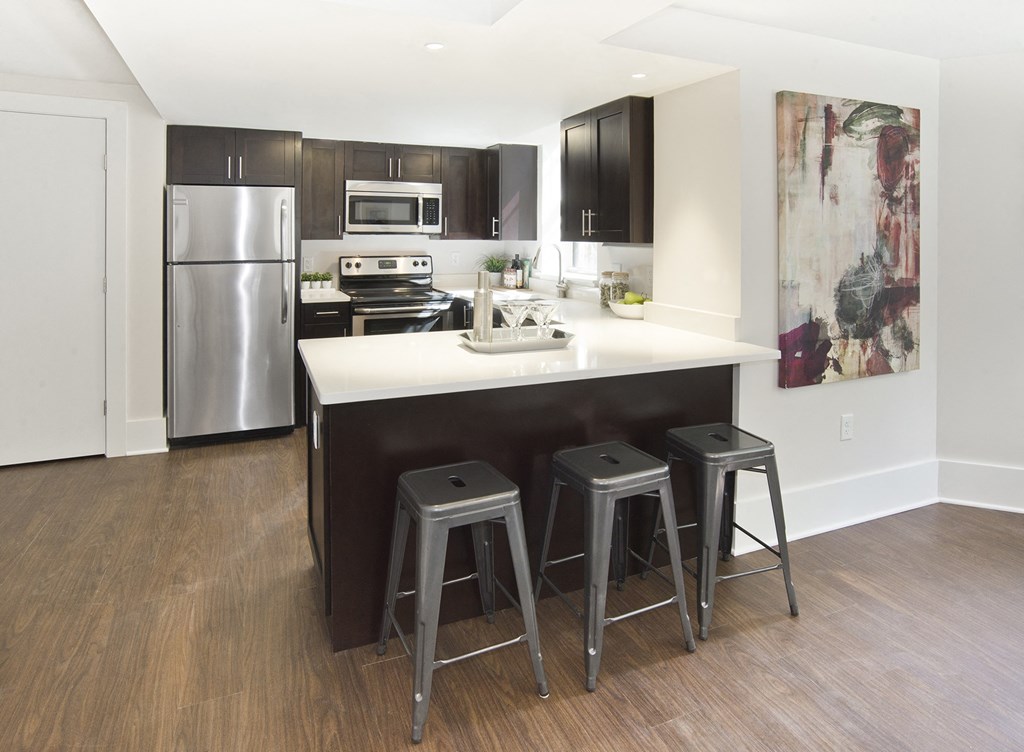 kitchen with a center island with three stools
