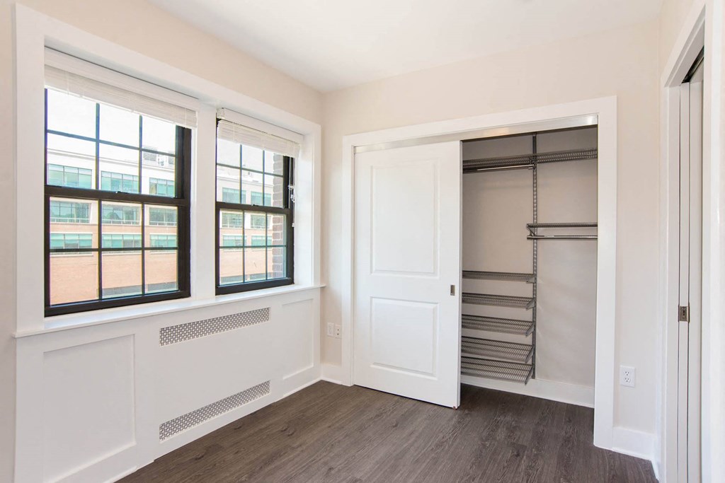 a white room with a window and a closet