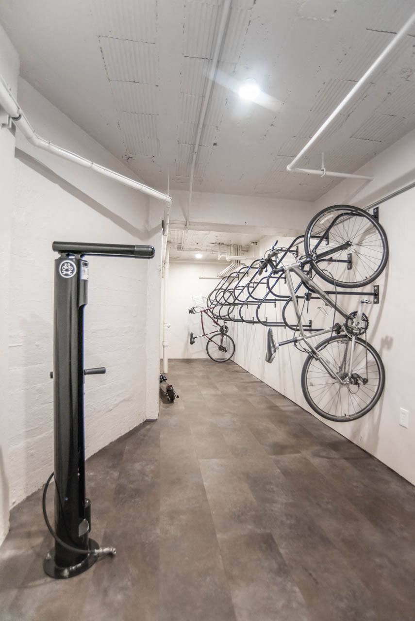 a row of bikes hanging on a wall in a room