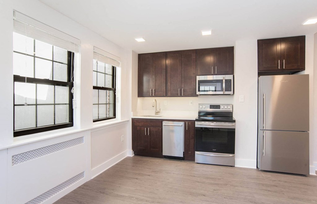 a kitchen with wooden cabinets and stainless steel appliances