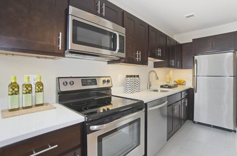 a kitchen with stainless steel appliances and a microwave