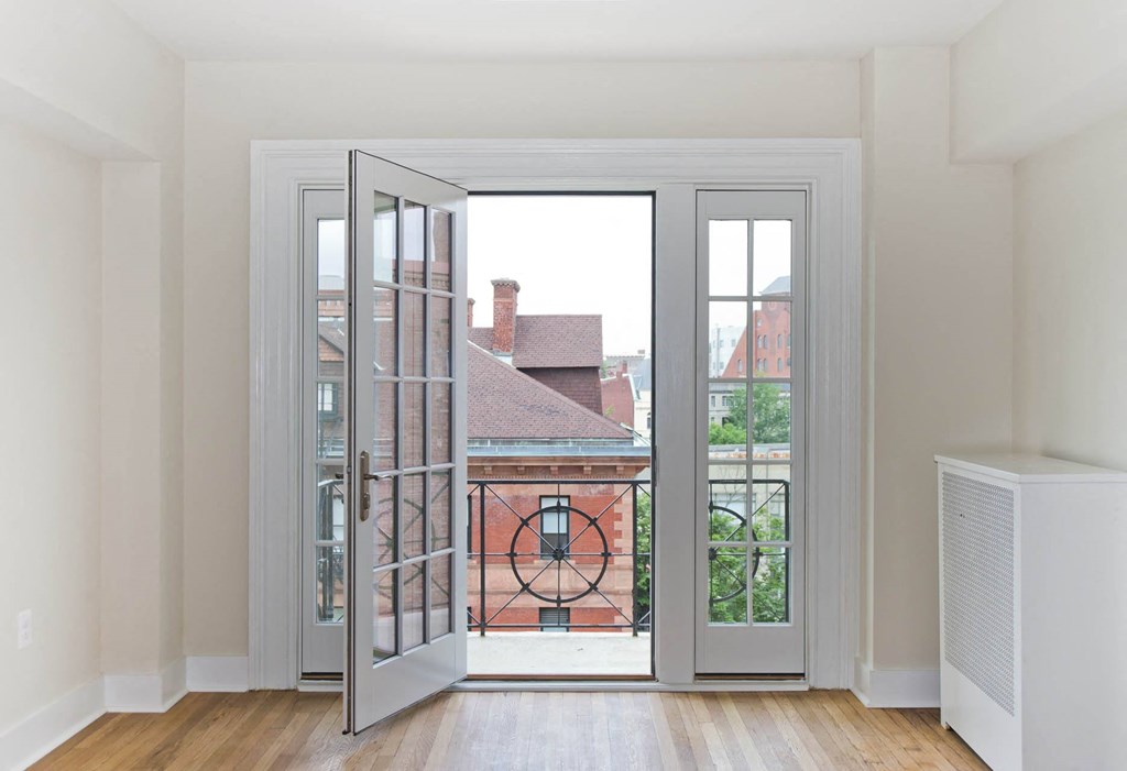 a living room with doors open to a balcony