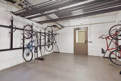 a room with bikes hanging on a wall and a door
