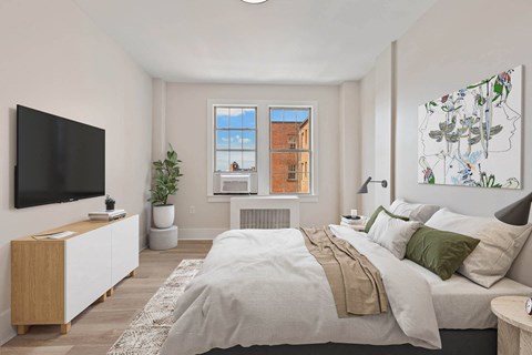 a bedroom with a bed and a tv