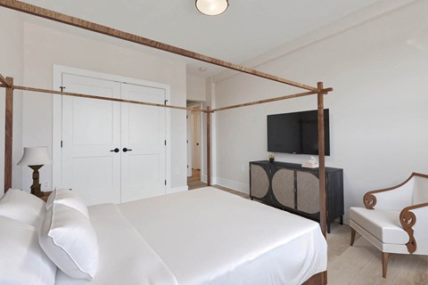 a bedroom with a bed and a tv