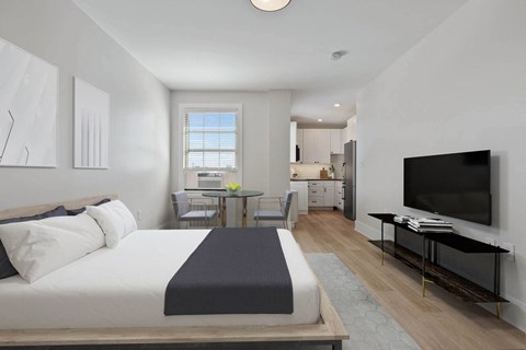 a bedroom with a bed and a tv