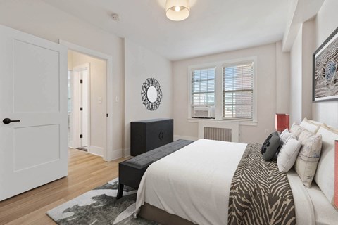 a bedroom with a bed and a door to a hallway