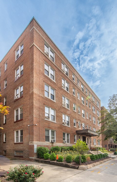 a large brick building with a sidewalk in front of it