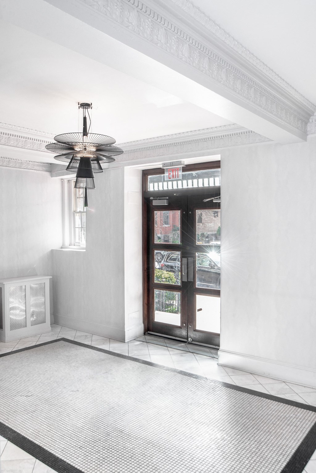 a view of a lobby with a door and a ceiling fan
