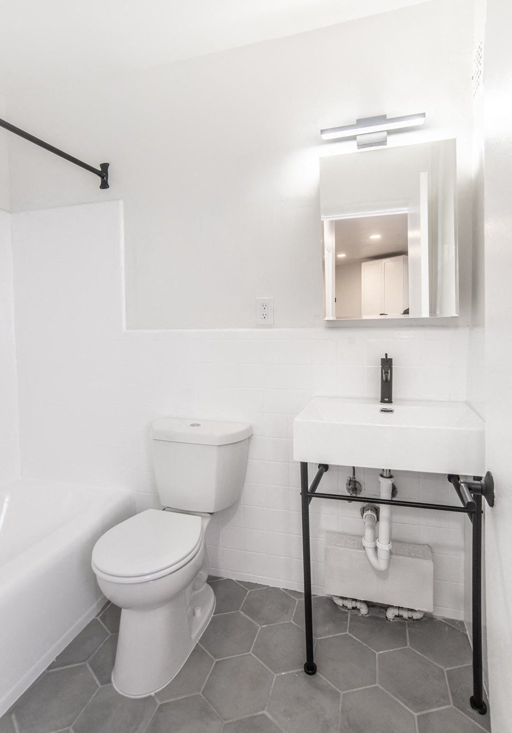 a bathroom with a sink toilet and bathtub