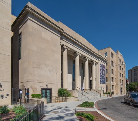 a large building with columns and a street in front of it