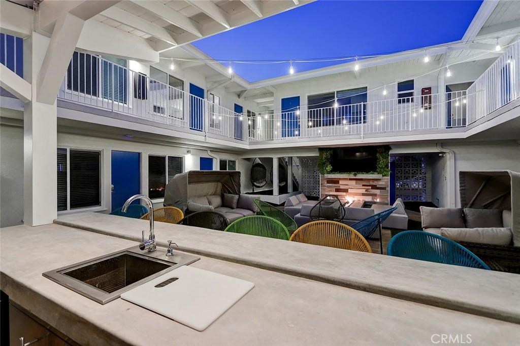 a kitchen with a sink and a living room