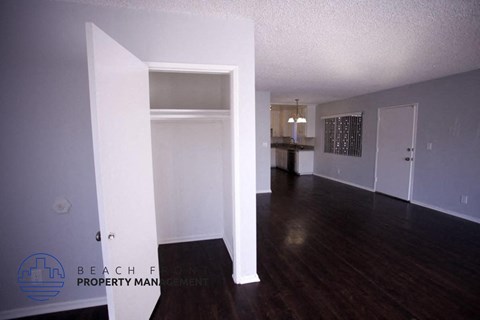 the living room and dining room of an empty apartment