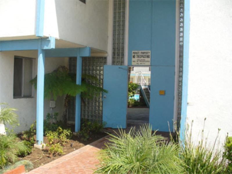 a blue and white building with a sign on the door