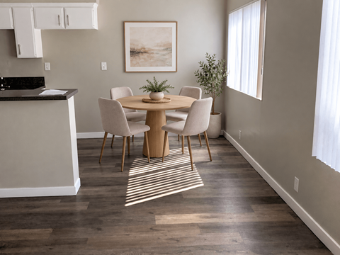 A dining room with a table set for four.
