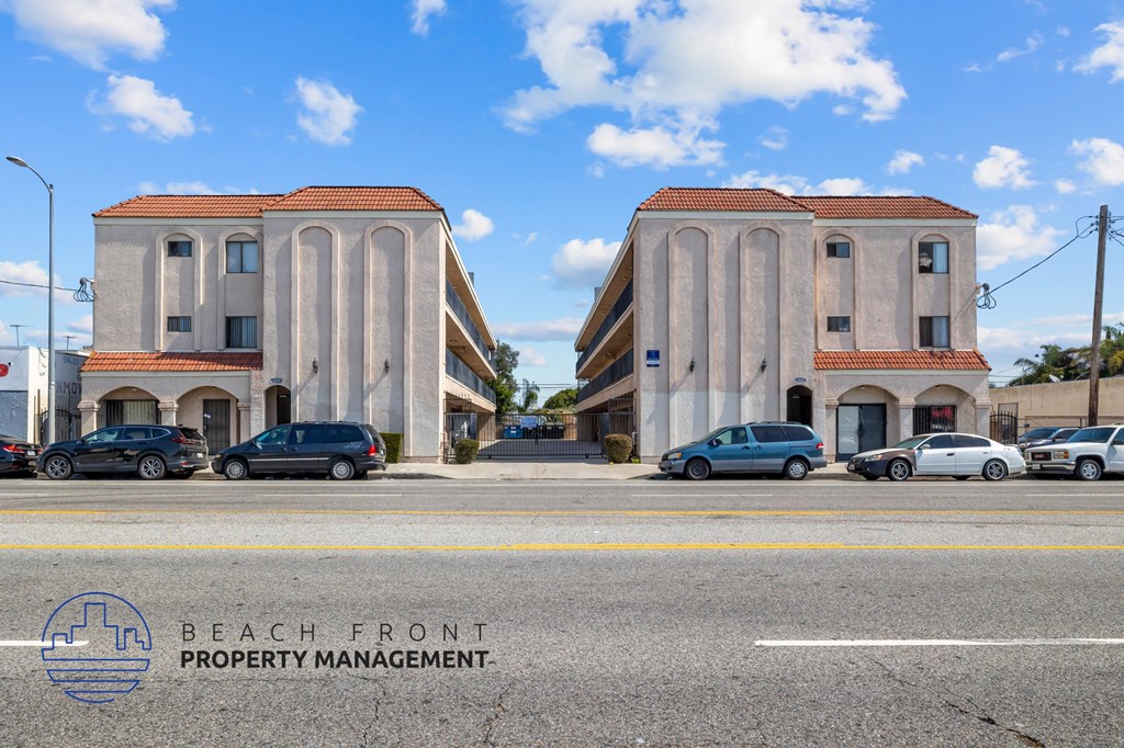 a view of a street with cars parked in front of buildings