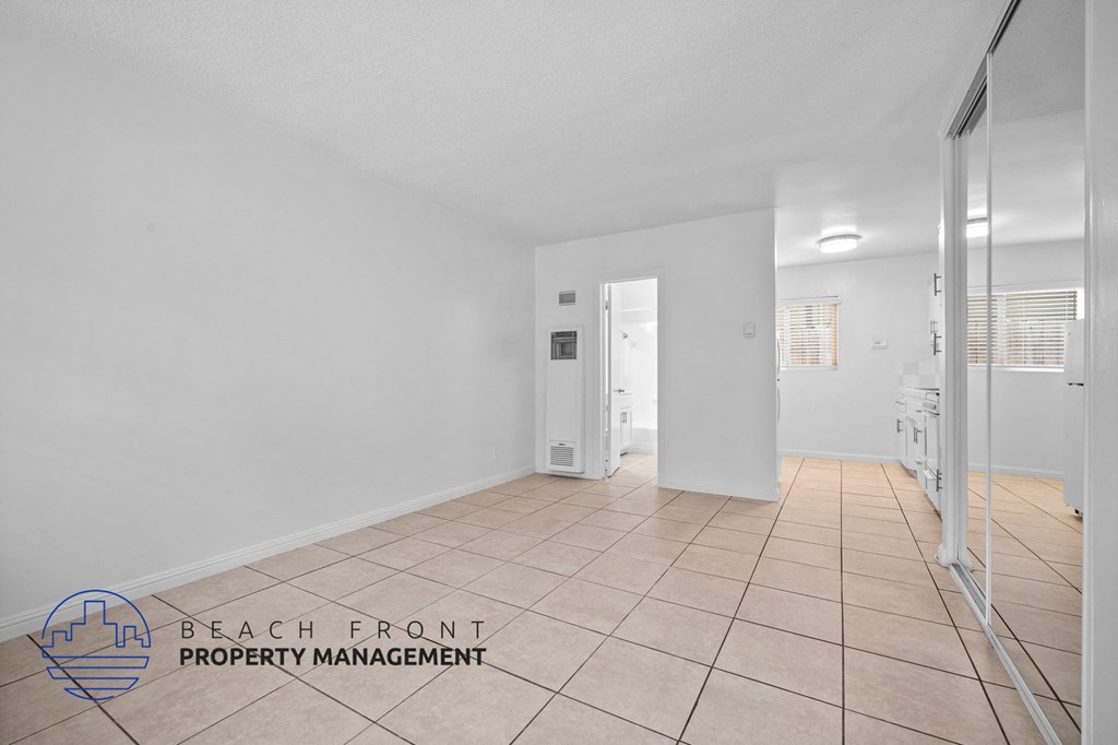 a renovated living room with a tiled floor and white walls