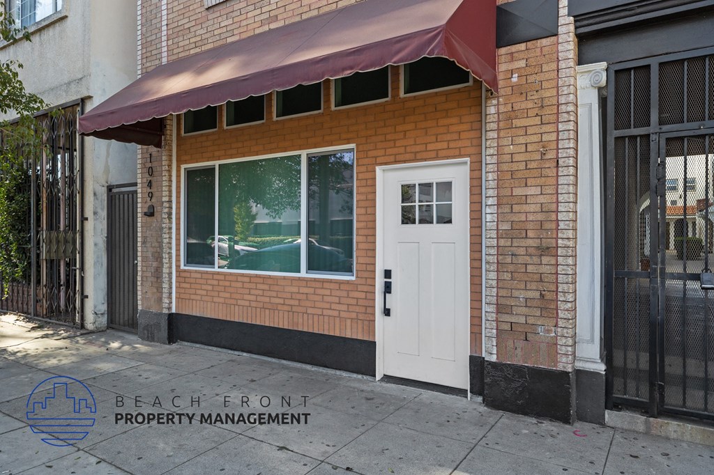 the front of a brick building with a white door