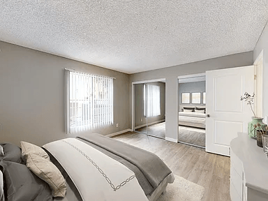 A bedroom with a large bed and a dresser.