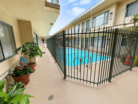 A black fence surrounds a small pool.