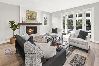 a living room with a couch and chair and a fireplace