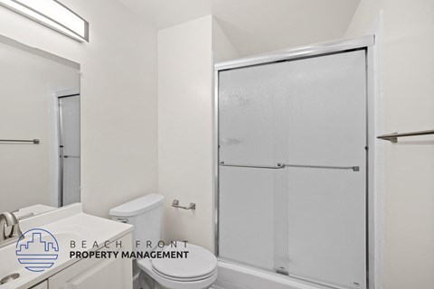 a bathroom with a shower and a toilet and a sink