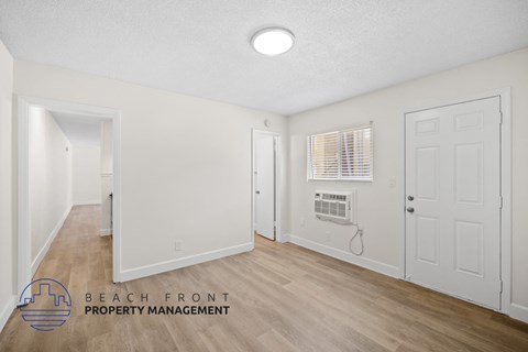 a living room with white walls and a white door