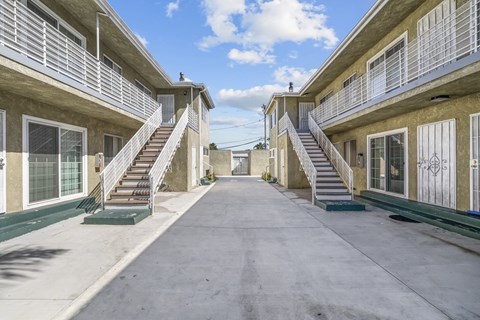 A sunny day at the apartment complex with a clear blue sky.