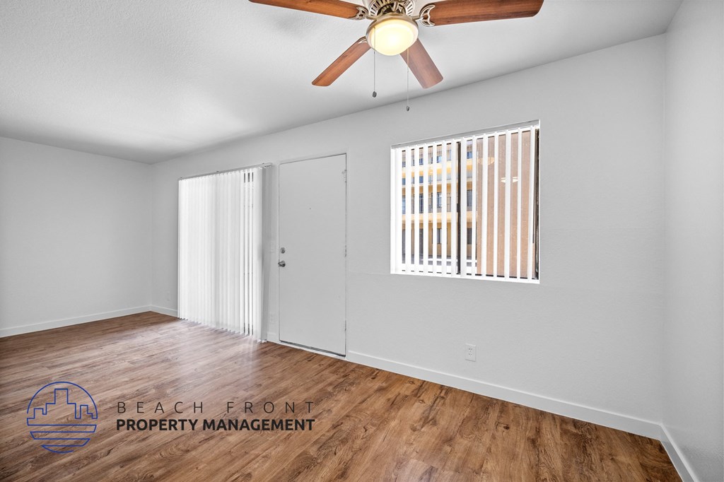 a living room with hardwood floors and a ceiling fan